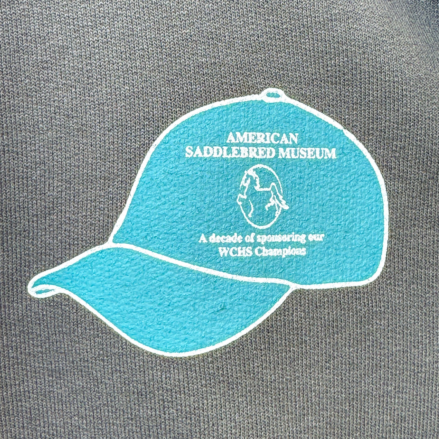 10th Anniversary WCHS Champion’s Hat Zip-Up Sweatshirt, Featuring Artwork by Andy Johns