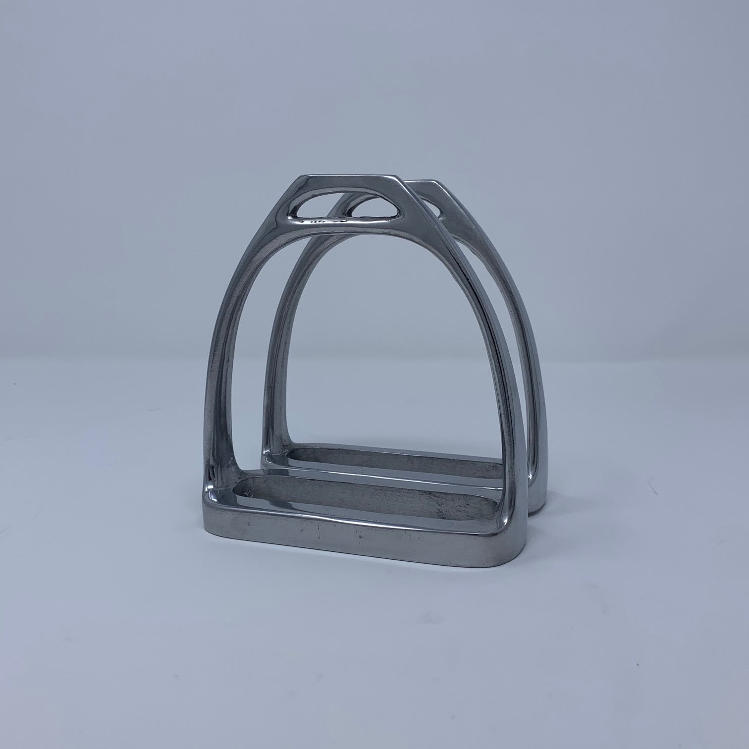 Two Side by Side Stirrups Form Napkin Holder Pictured Empty at Angle
